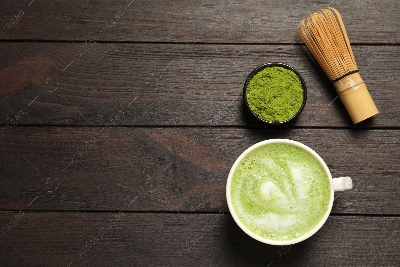 Photo of Flat lay composition with tasty matcha latte on dark wooden table, space for text