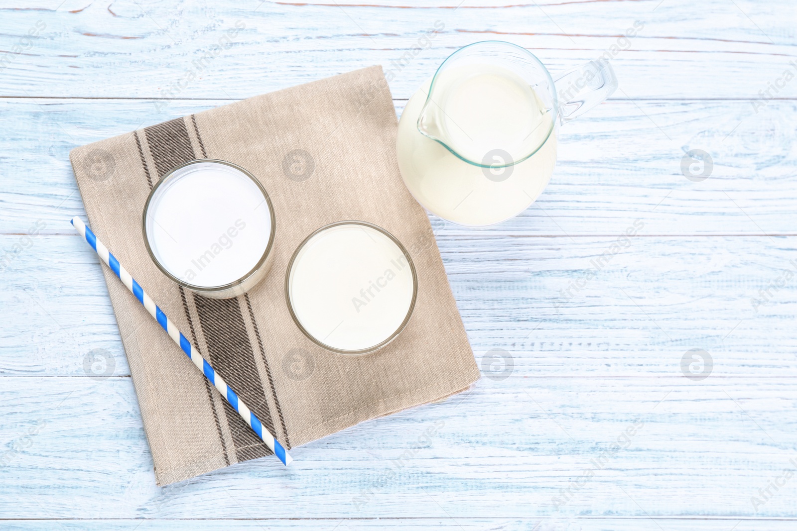 Photo of Glassware with milk on wooden table. Fresh dairy product