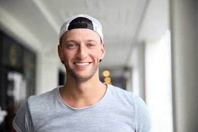 Photo of Handsome young man in stylish cap indoors