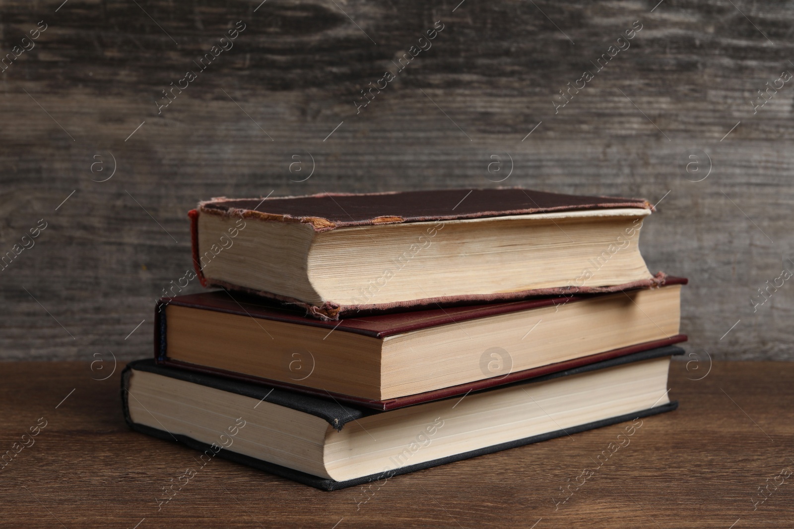 Photo of Stack of old hardcover books on wooden table