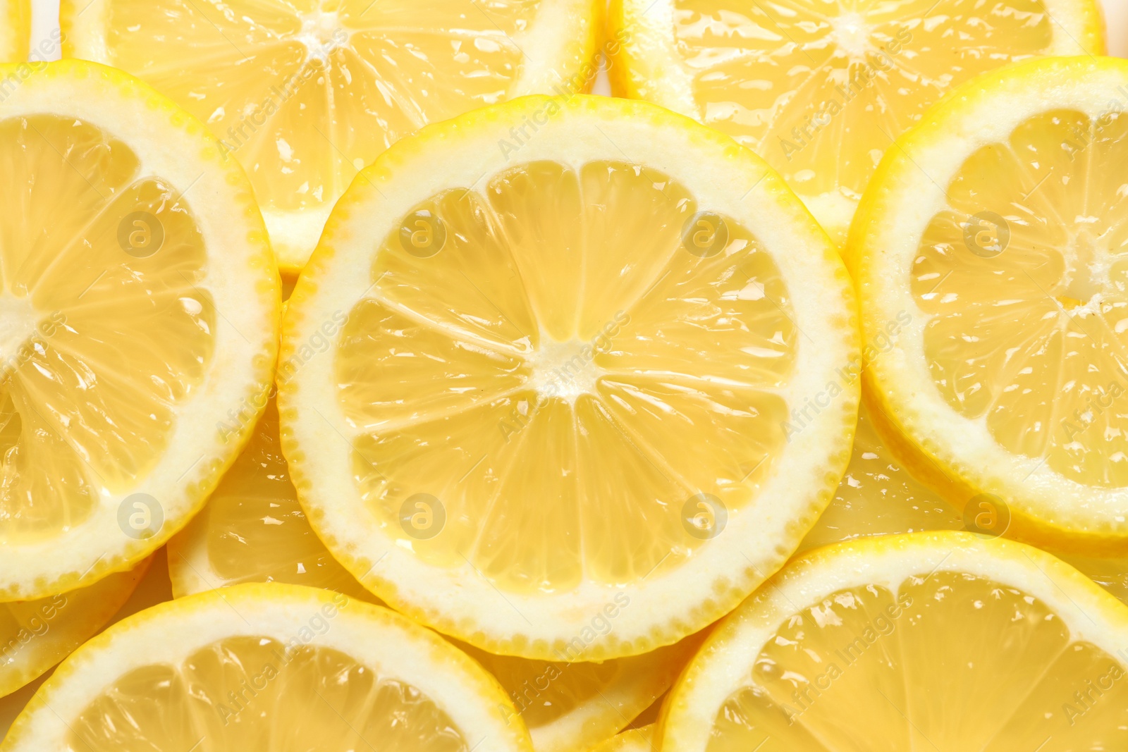 Photo of Juicy lemon slices as background, top view. Citrus fruit