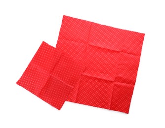 Red reusable beeswax food wraps on white background, top view