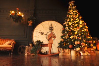 Photo of Blurred view of stylish room interior with Christmas tree, big vintage clock and festive decor