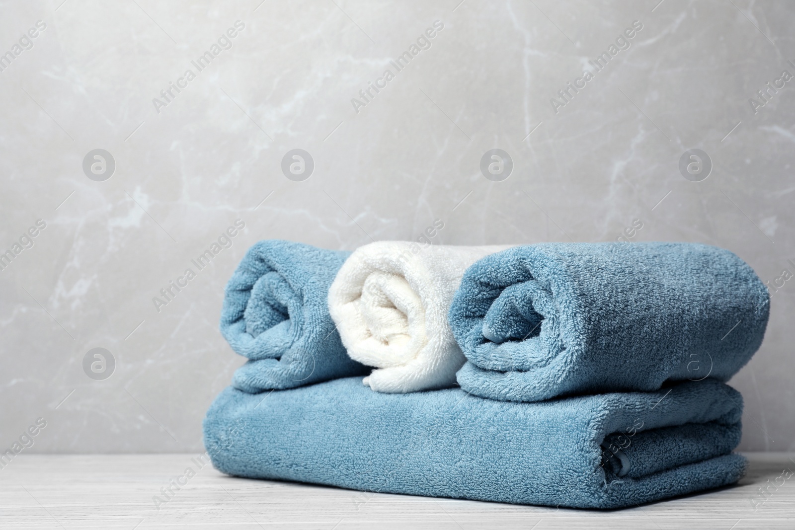 Photo of Fresh towels on table. Space for text