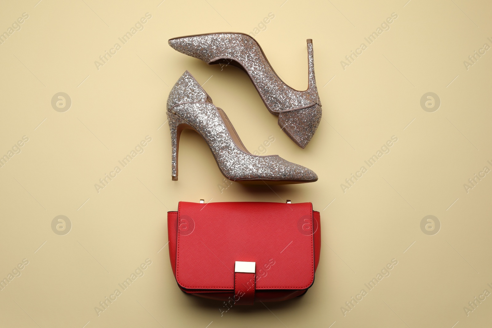 Photo of Stylish woman's bag and shoes on beige background, flat lay