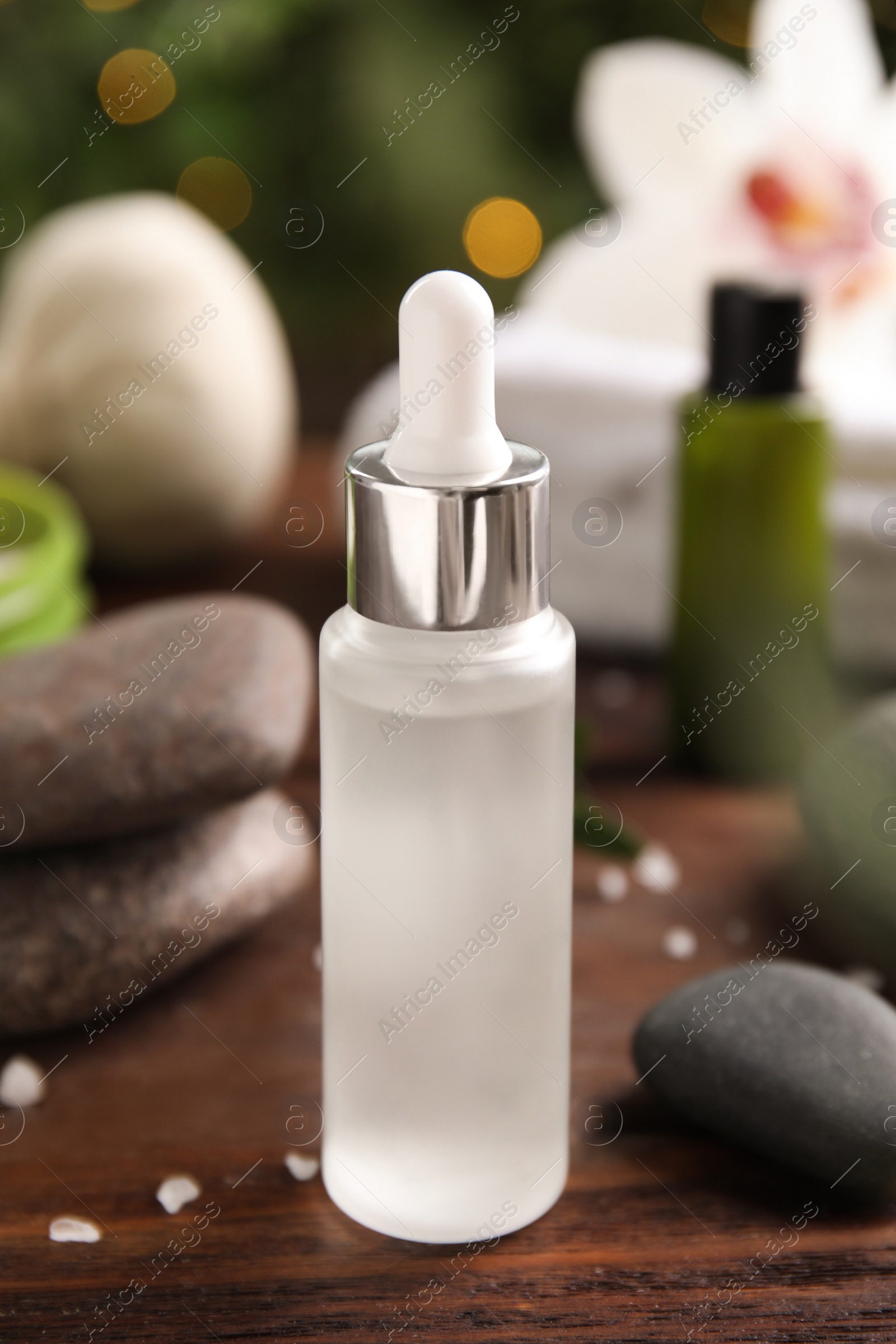 Photo of Composition with spa cosmetic on wooden table, closeup