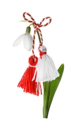 Photo of Beautiful snowdrop with traditional martisor on white background. Symbol of first spring day