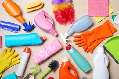 Photo of Flat lay composition with cleaning supplies on wooden background