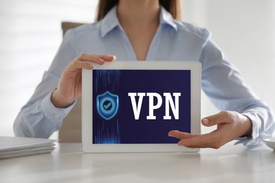 Image of Woman holding modern tablet with switched on VPN indoors, close up