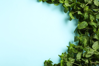 Photo of Fresh aromatic mint on light blue background, top view. Space for text