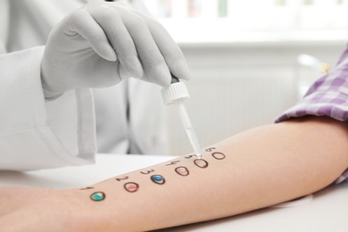 Photo of Patient undergoing skin allergy test at light table, closeup