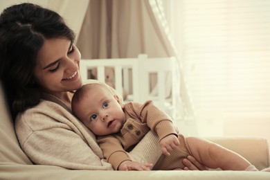 Photo of Happy young mother with her cute baby at home