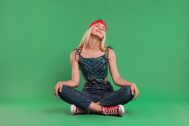 Photo of Portrait of happy hippie woman on green background