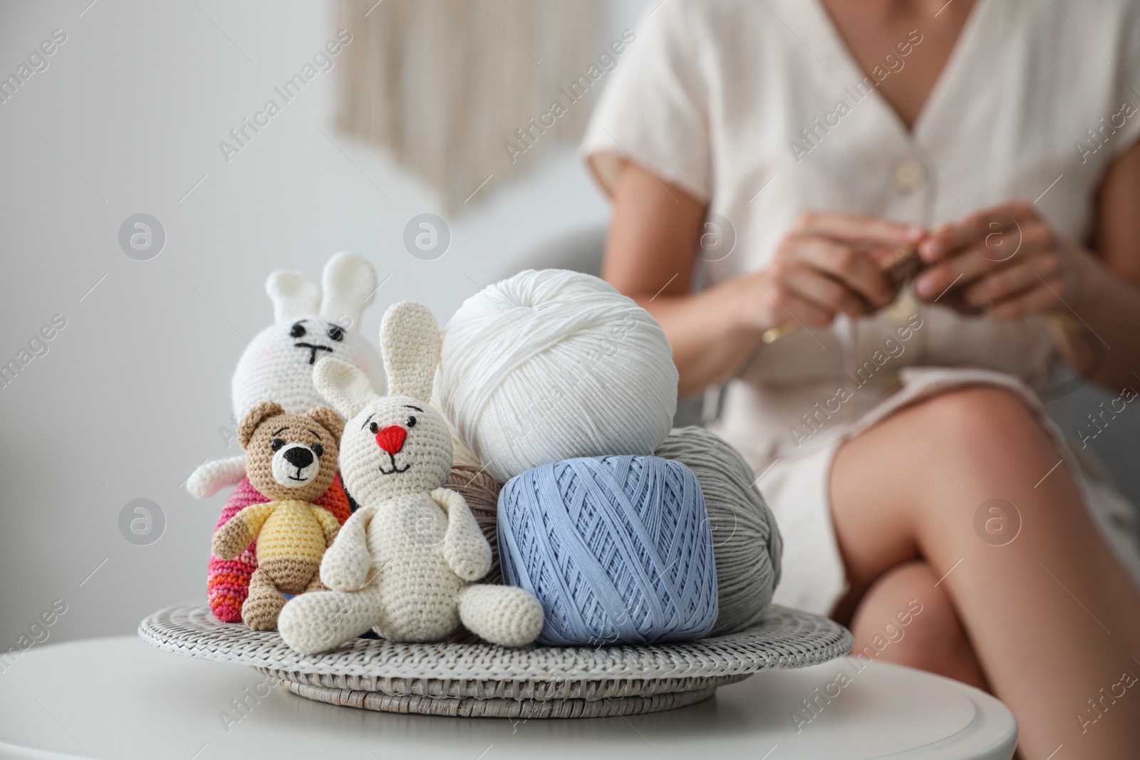 Photo of Crocheted toys and clews on table. Engaging in hobby