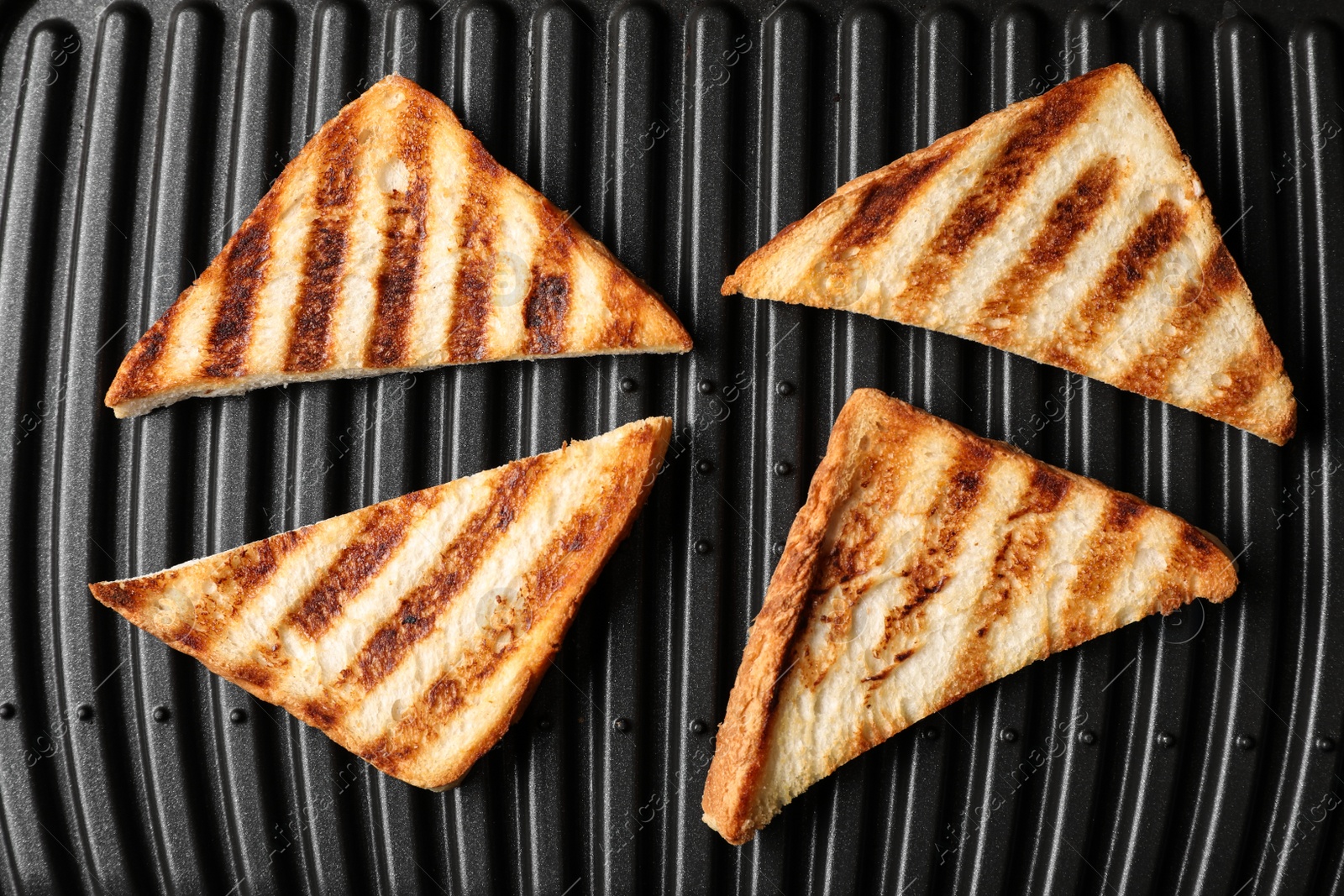 Photo of Modern sandwich maker with bread slices, top view