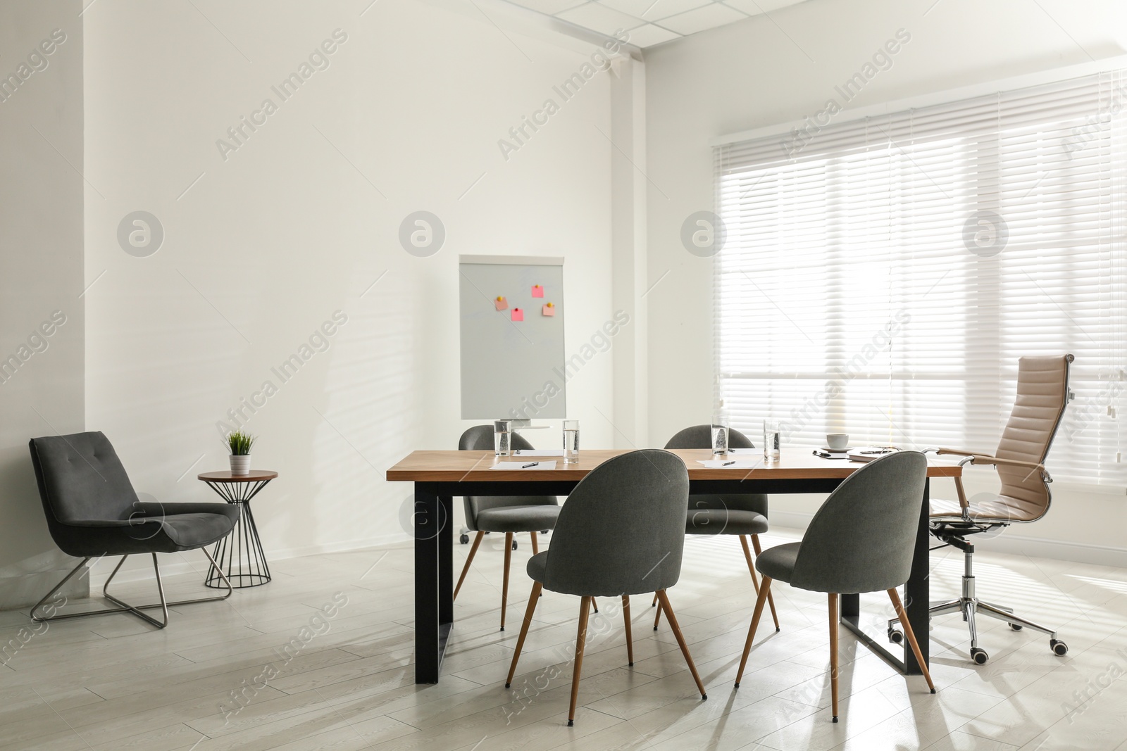 Photo of Simple office interior with large table and chairs