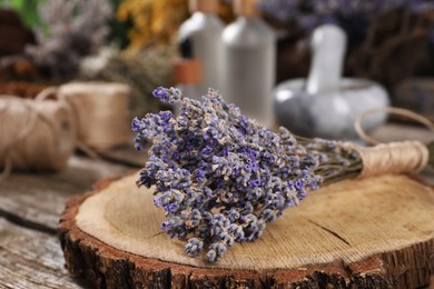 Photo of Dry lavender flowers on wooden table, closeup. Medicinal herbs