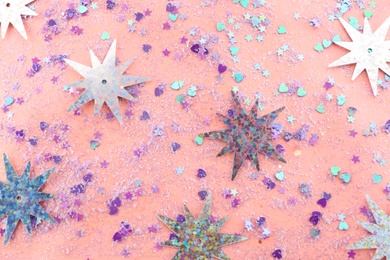 Photo of Shiny glitter on light pink background, flat lay