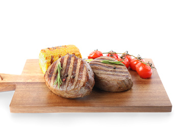 Photo of Delicious beef medallions served with vegetables isolated on white