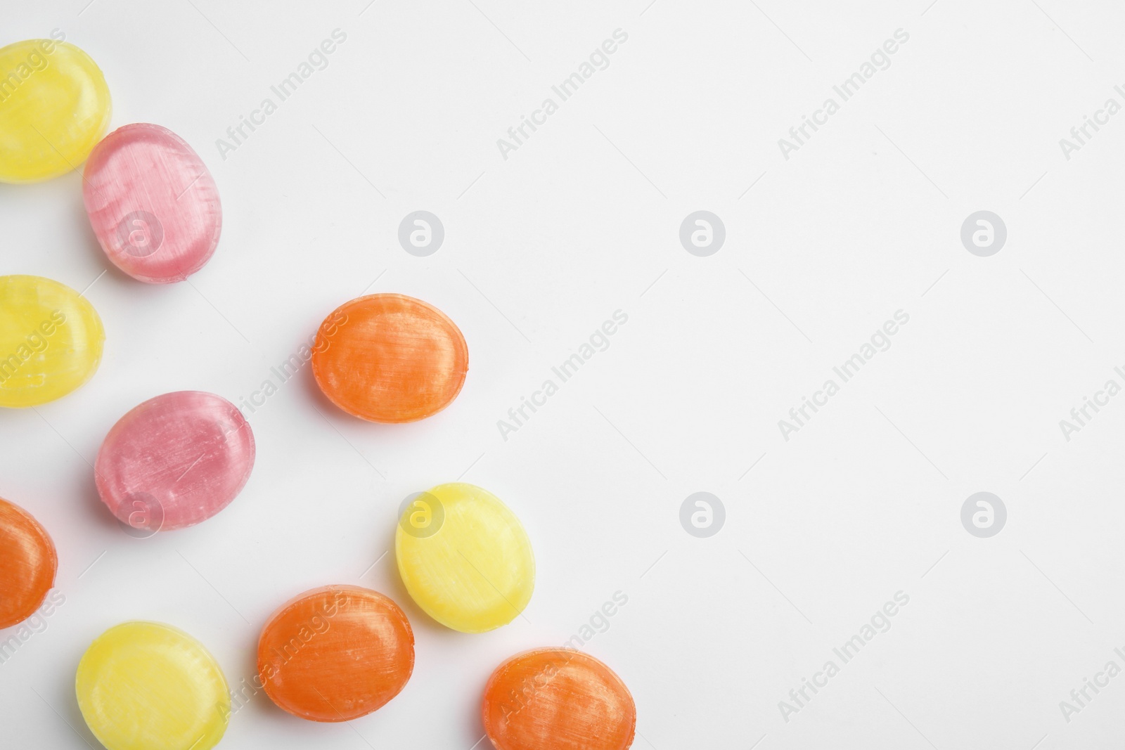 Photo of Delicious colorful candies on white background, top view