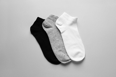 Photo of Different socks on light grey background, flat lay