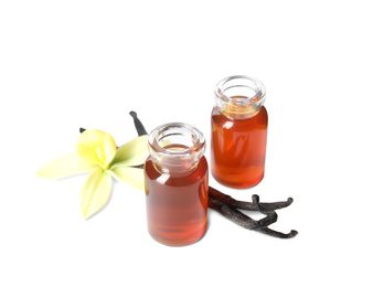 Photo of Vanilla extract, flower and dry pods isolated on white