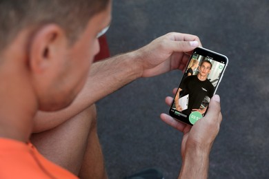 Image of Man having workout with personal trainer via smartphone, closeup