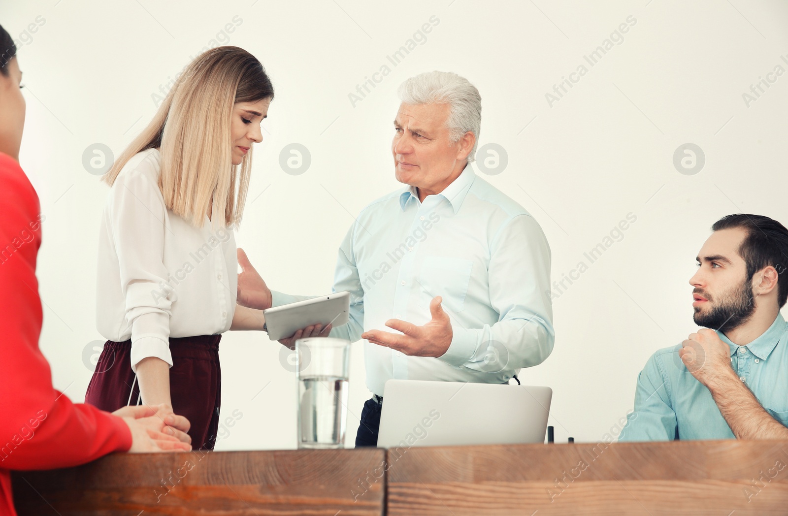 Photo of Office employees having argument during business meeting