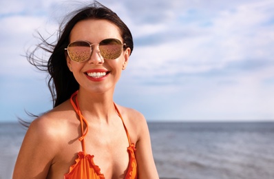 Beautiful young woman in bikini on beach