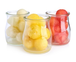 Photo of Glass jars of melon and watermelon balls on white background