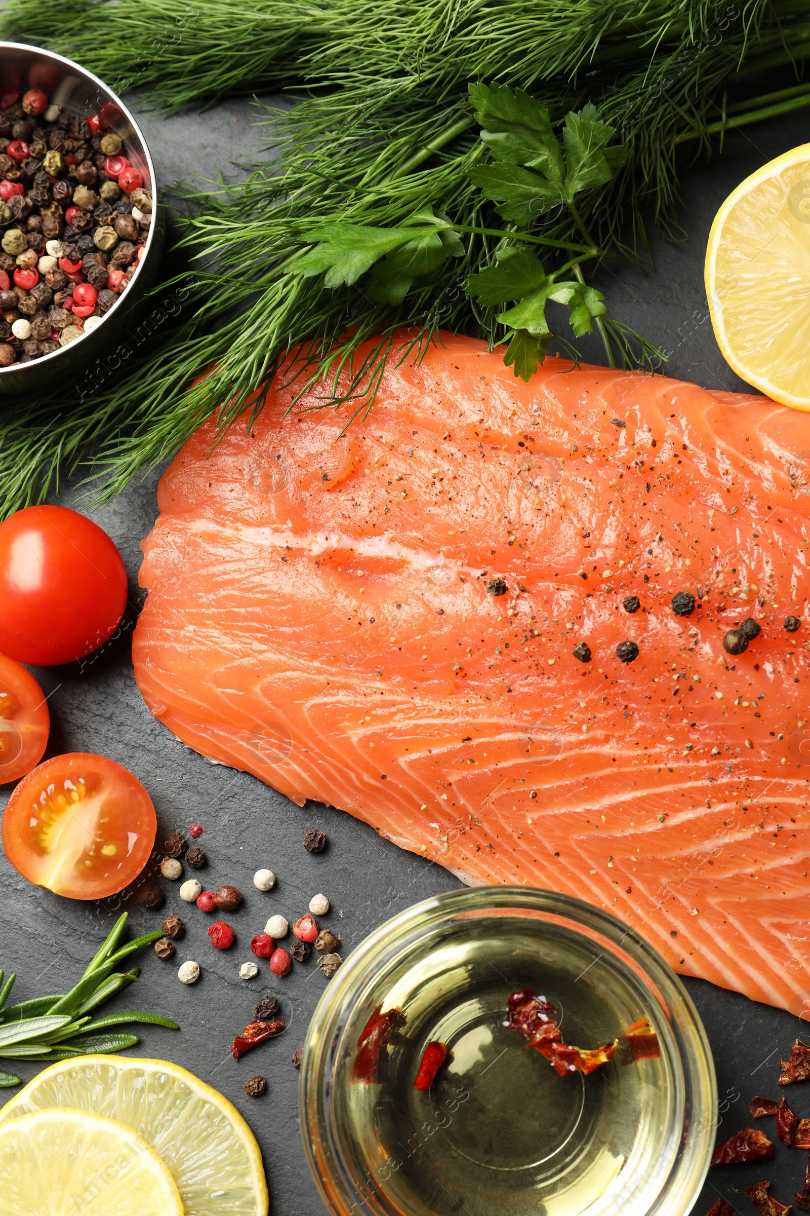 Photo of Fresh raw salmon and ingredients for marinade on black table, flat lay