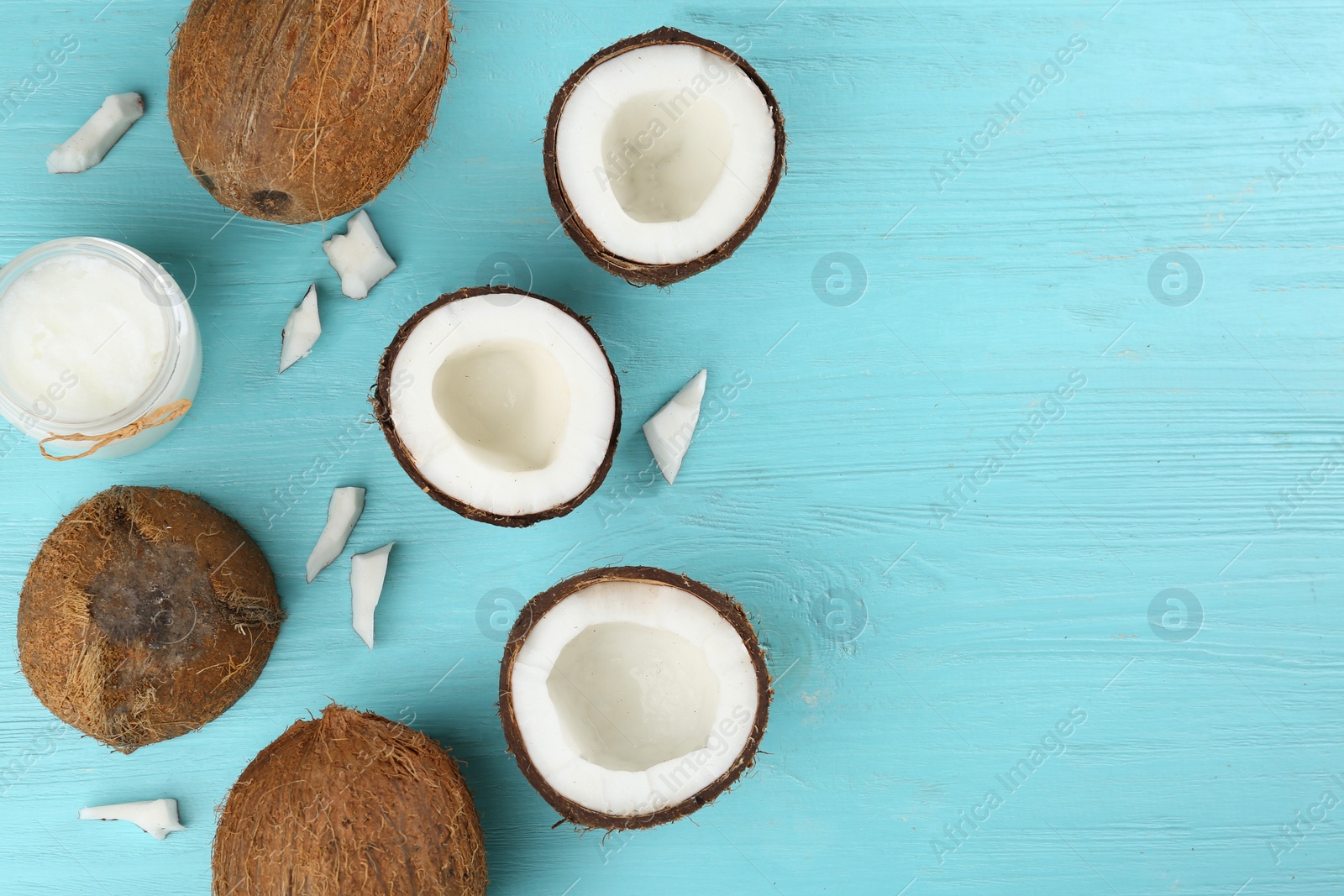 Photo of Flat lay composition with organic coconut oil on light blue wooden table, space for text. Healthy cooking