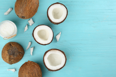 Flat lay composition with organic coconut oil on light blue wooden table, space for text. Healthy cooking