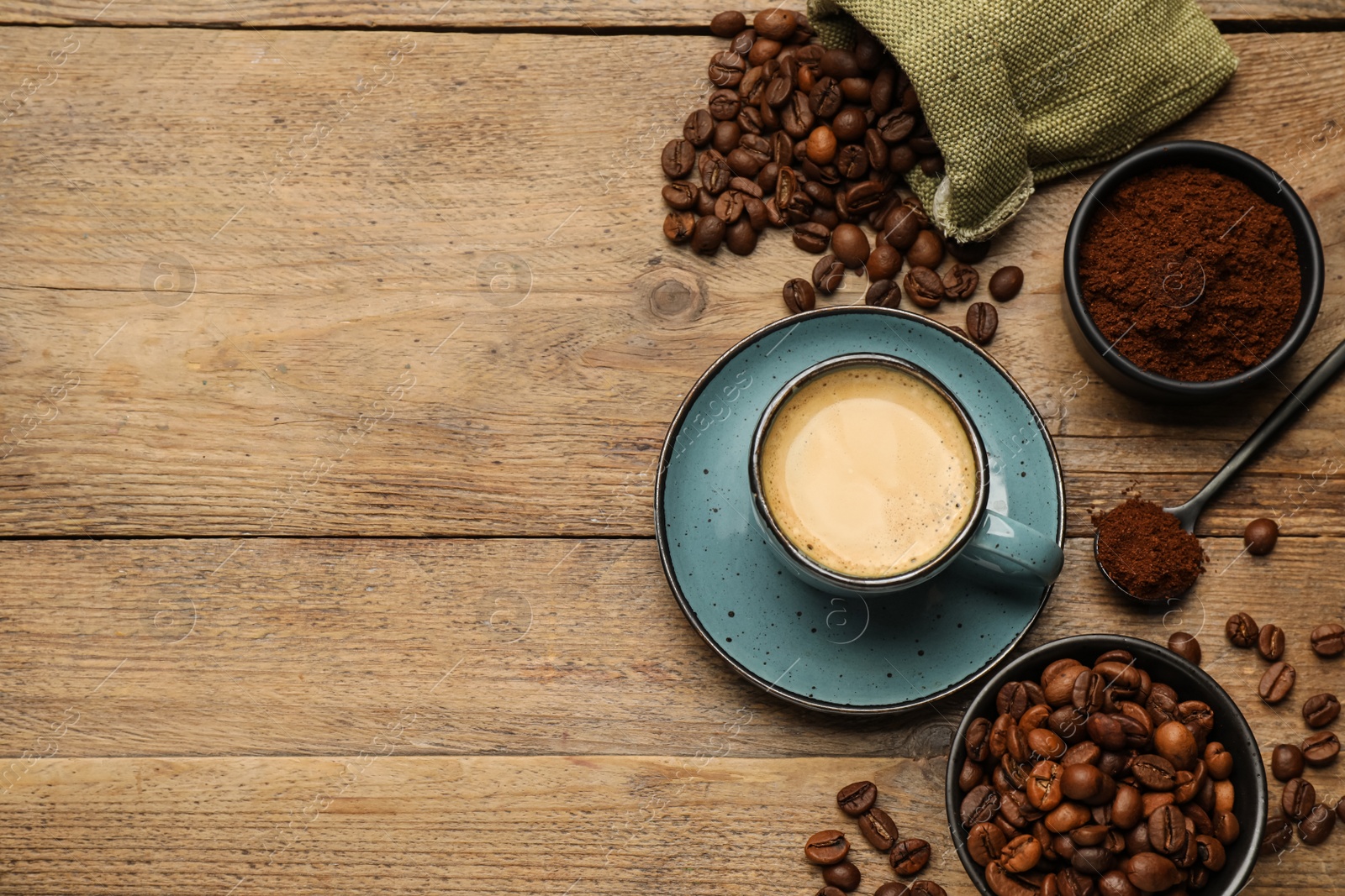 Photo of Flat lay composition with coffee grounds and roasted beans on wooden table, space for text