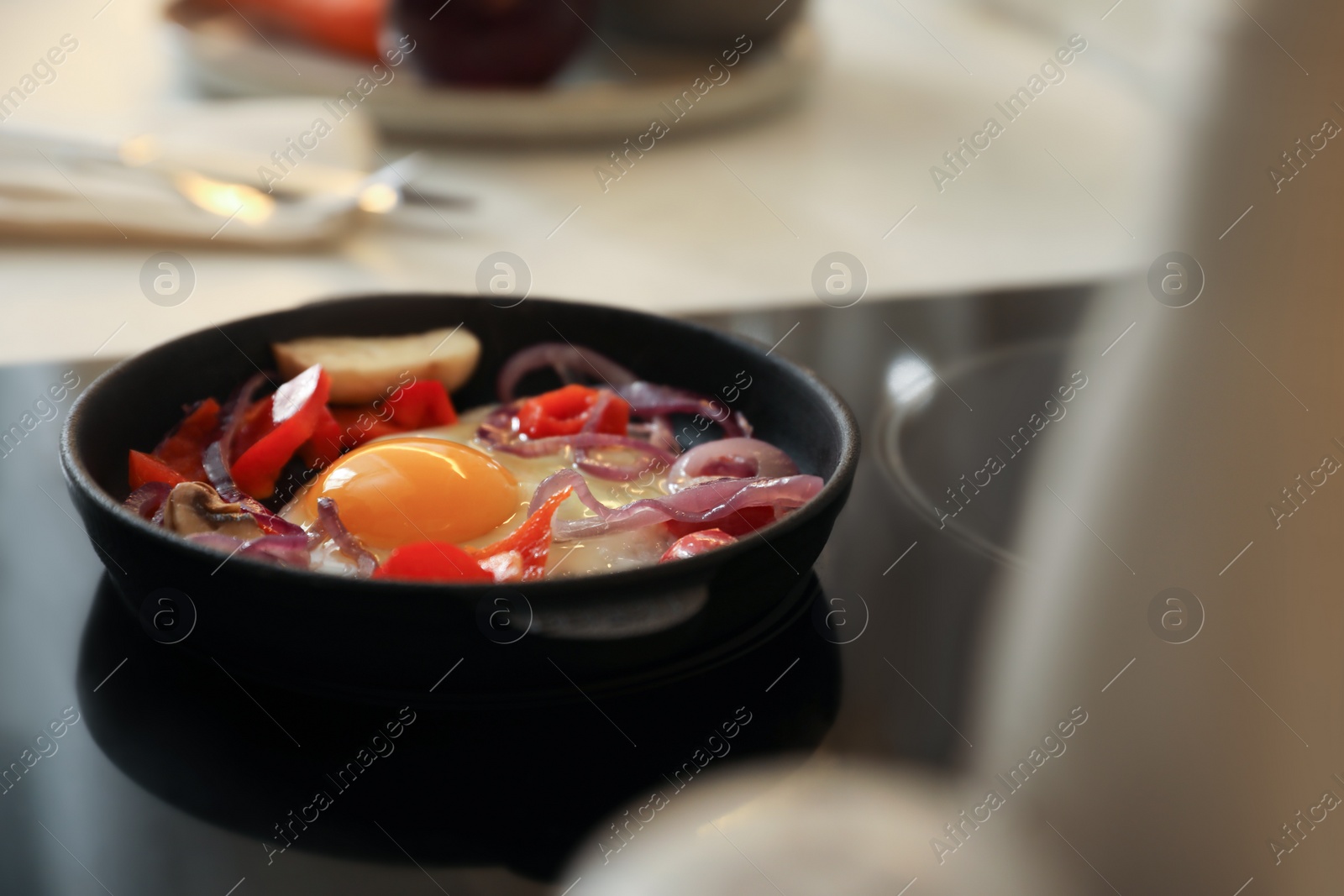 Photo of Frying pan with tasty egg and vegetables on stove