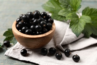 Ripe blackcurrants and leaves on wooden rustic table