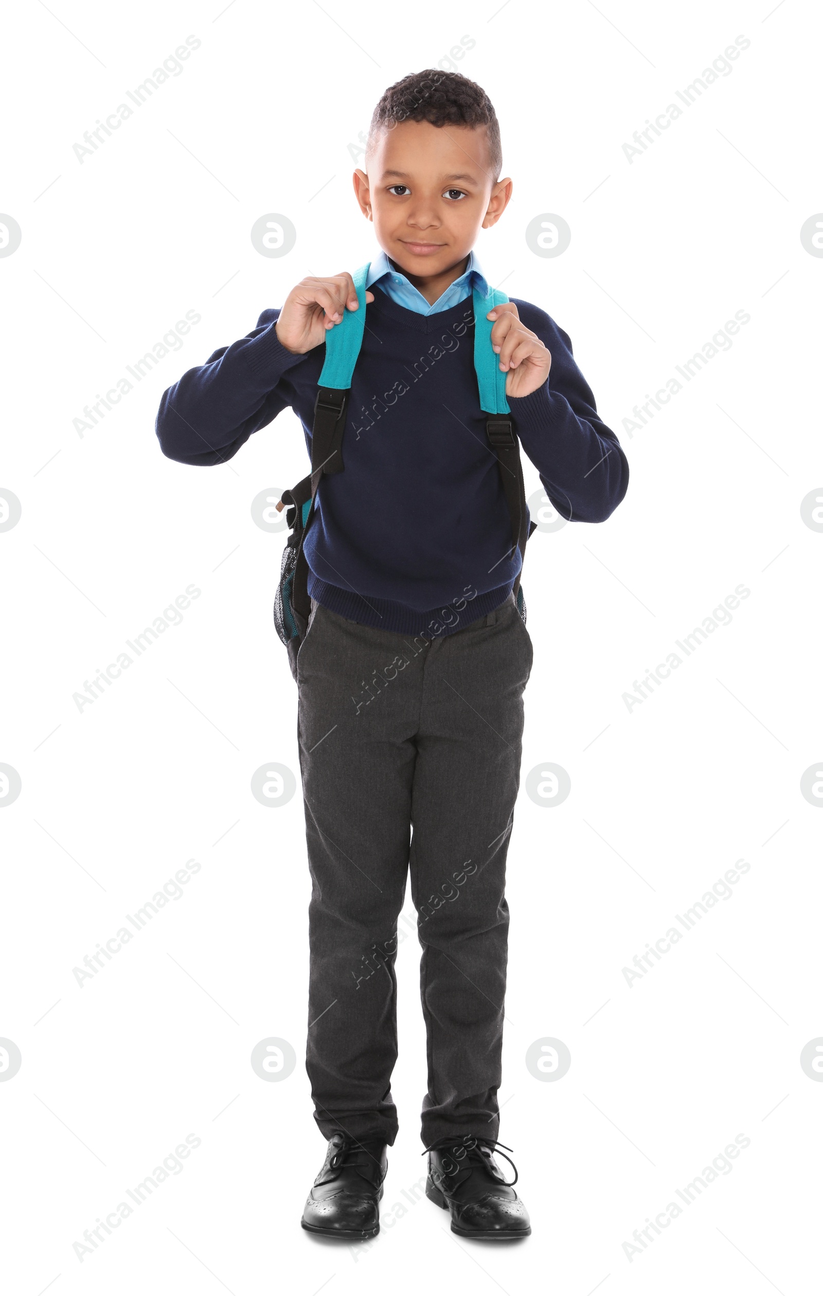 Photo of Full length portrait of cute African-American boy in school uniform with backpack on white background