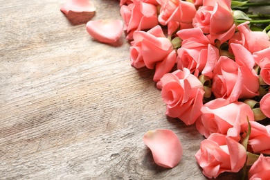 Beautiful roses on wooden table