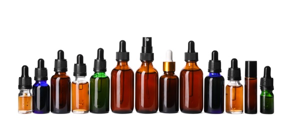 Photo of Cosmetic bottles of essential oils on white background