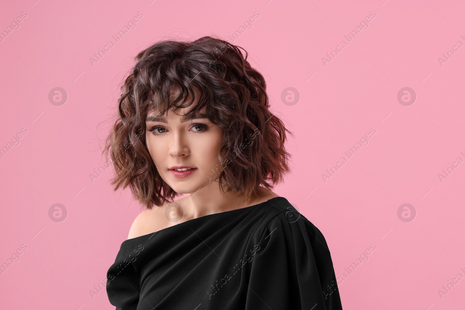 Photo of Portrait of beautiful young woman with wavy hairstyle on pink background. Space for text