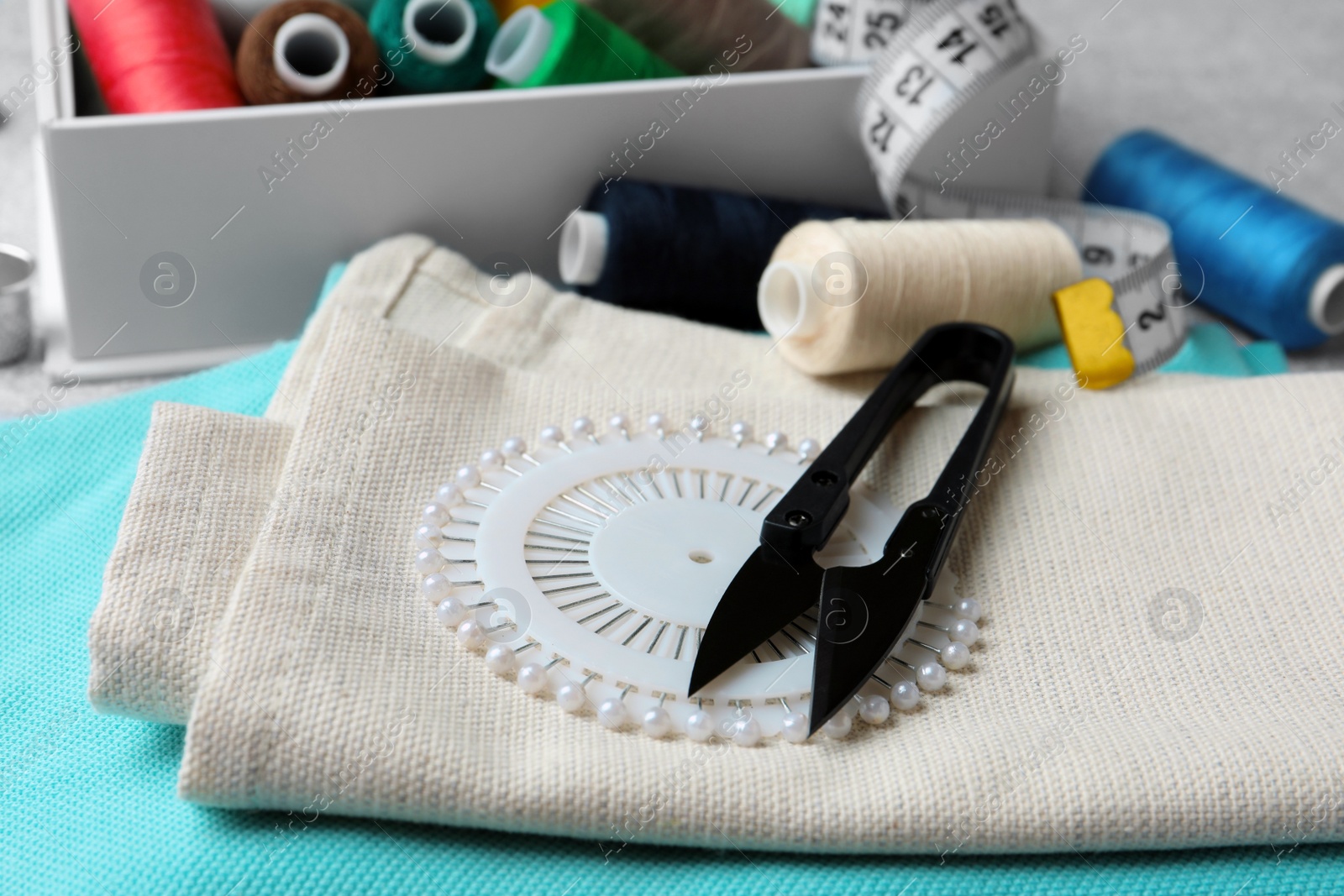 Photo of Spools of threads and sewing tools on table