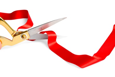 Photo of Ribbon and scissors on white background. Ceremonial red tape cutting