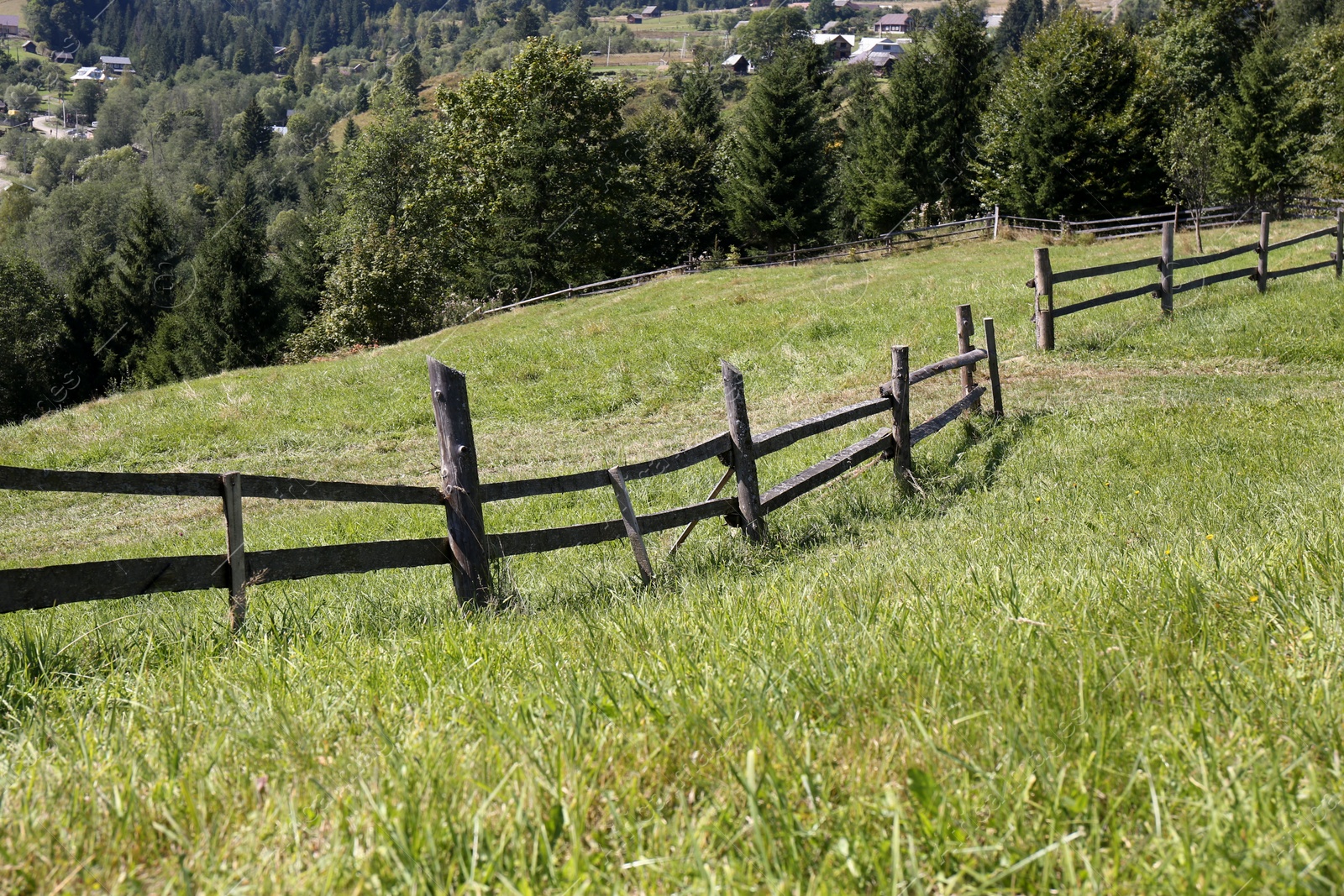 Photo of Beautiful view of mountain countryside with wooden fence