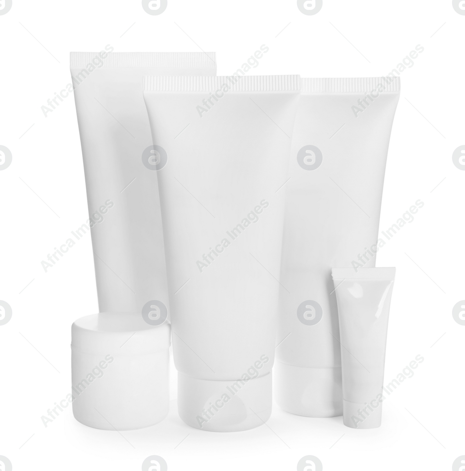 Photo of Blank tubes and jars of cosmetic products on white background