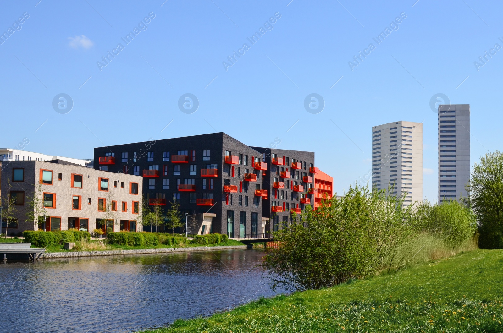 Photo of Cityscape with beautiful modern buildings and canal on sunny day