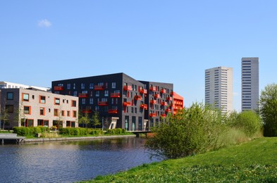 Cityscape with beautiful modern buildings and canal on sunny day