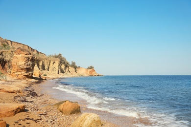 Photo of Picturesque view of beautiful beach with cliff