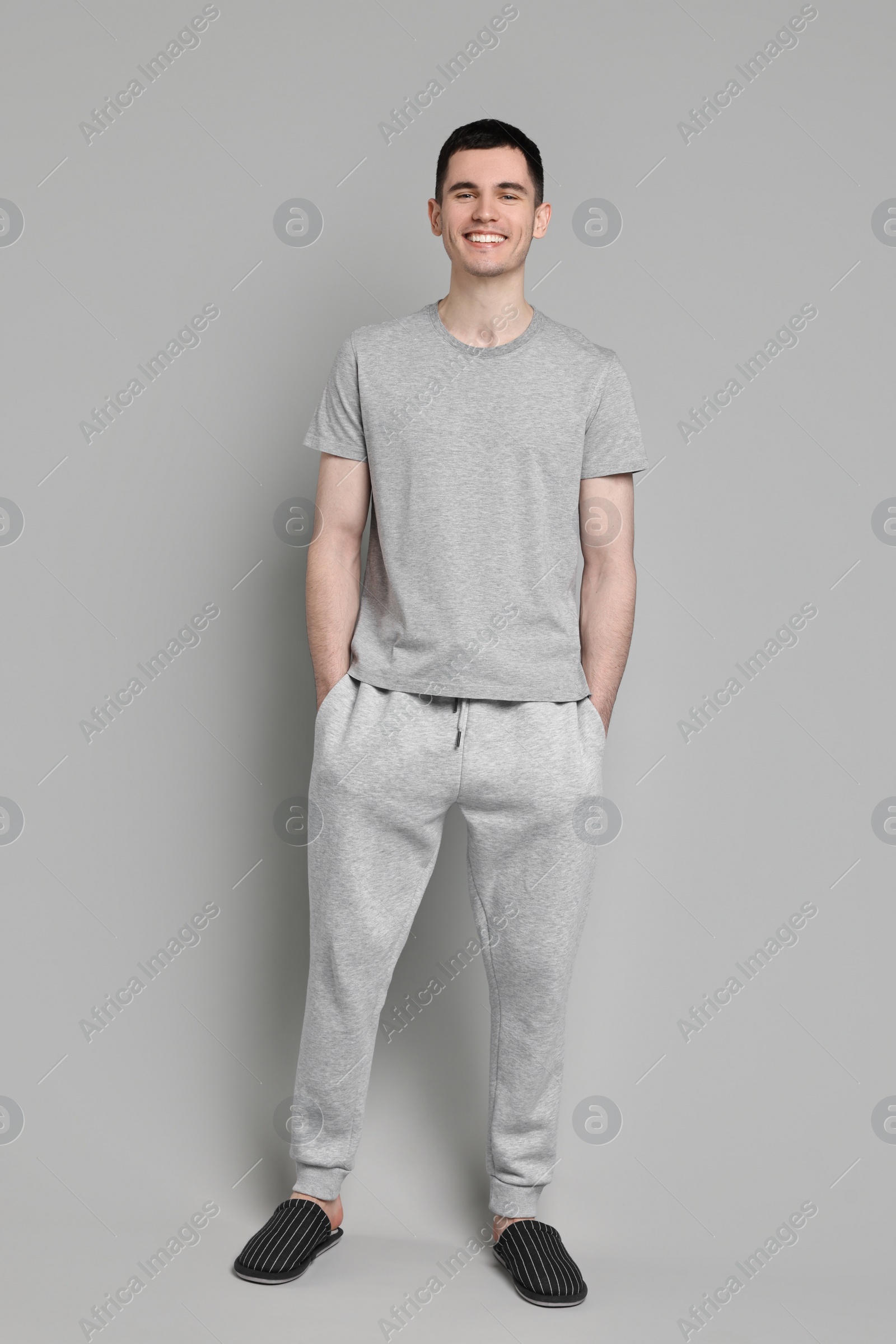 Photo of Happy man in pyjama on grey background