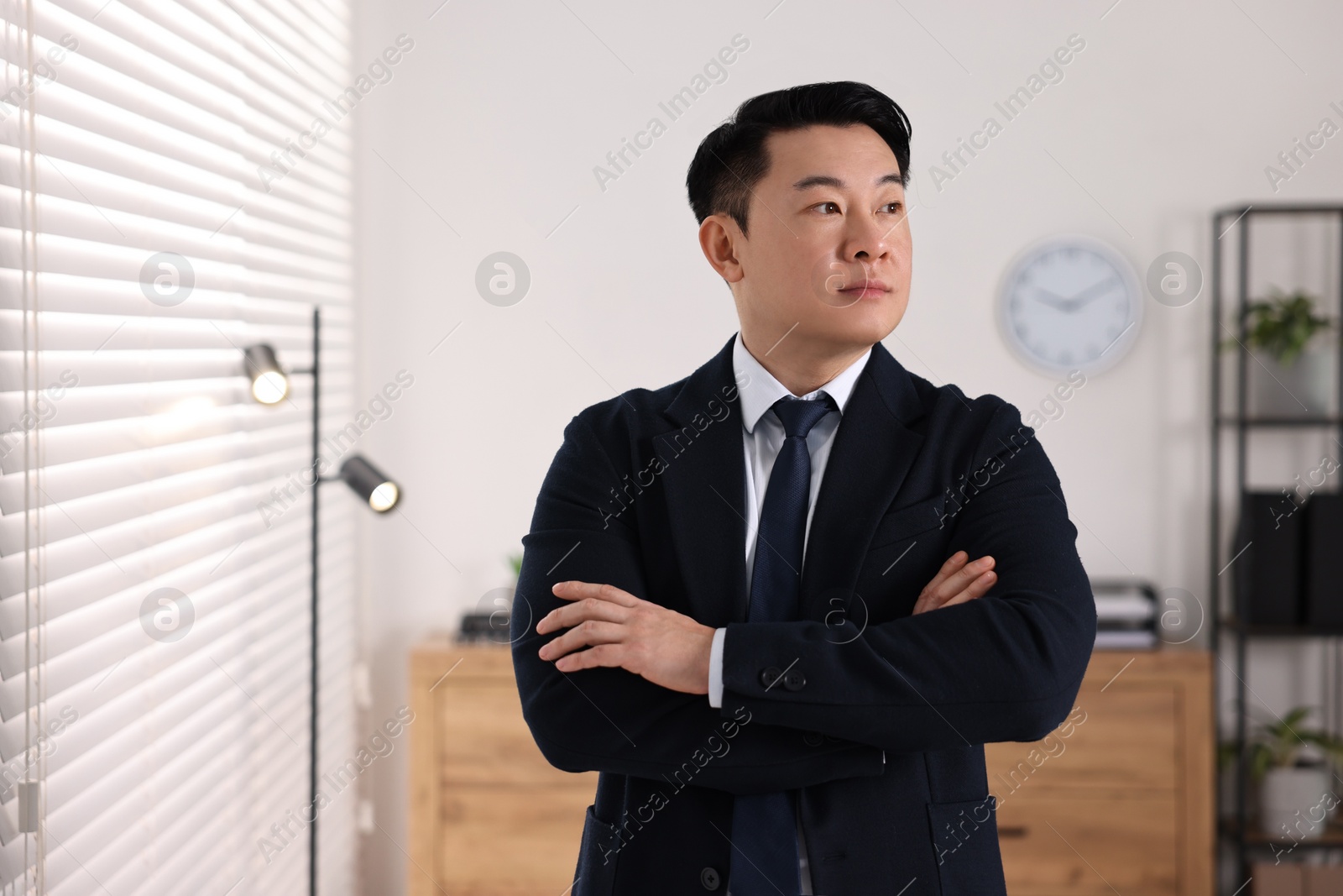 Photo of Portrait of confident notary with crossed arms in office, space for text