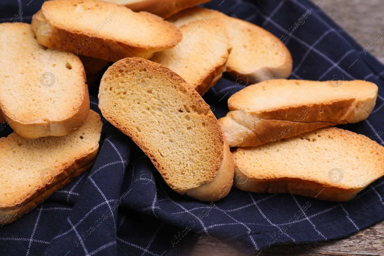 Photo of Tasty hard chuck crackers on wooden table